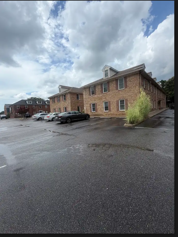 Free parking lot in front of the brick office building on South Plaza Trail